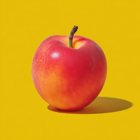 Ripe apricot radiating freshness on a bright yellow background, showcasing its natural perfection.の素材
