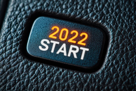 Close-Up of Illuminated 2022 Car Start Engine Button on Luxurious Black Leather Interior Designの素材