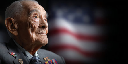 Portrait of a Proud, Elderly American Veteran Honoring Veterans Day with the American Flagの素材