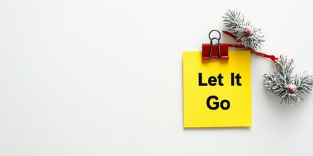 Winter Wonderland Yellow Sticky Note with Let It Go Message Surrounded by Pine Branch Decorationsの素材