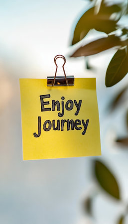 Yellow Sticky Note With Enjoy Journey Message, Symbol Of Positive Affirmations And Motivationの素材