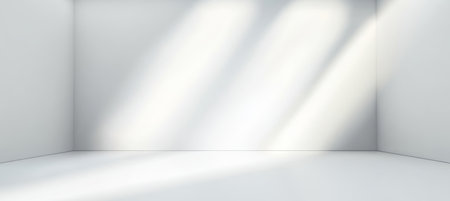 Bright Interior Studio Design with Sunlight Rays and Textured Backdrop for Creative Photographyの素材