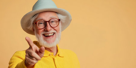 Joyful Senior Man with Hat Smiling and Pointing Finger, Confident Vintage Business Portraitの素材