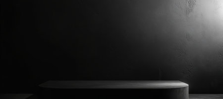 Elegant Black Surface for Product Presentation with Dark Shadows in a Luxury Mockup Settingの素材