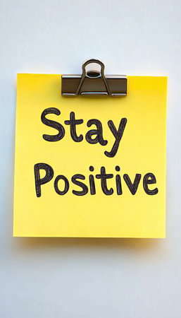 Colorful Adhesive Note on White Background with Positive Message to Encourage Optimismの素材