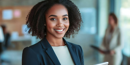 Confident Businesswoman Portrait Smiling Black Woman in Modern Office Holding Tablet and Laptopの素材