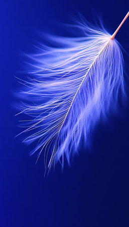 Delicate Seed Plume Floating in the Air, Captured in a Dreamlike Blue and White Aestheticの素材