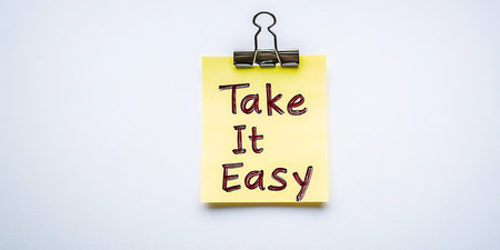 A Bright Yellow Note with a Paperclip Reminding You to Take Time to Relax and Focus on Wellbeingの素材