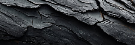 Textured Black Slate Background Evoking Primeval Terrain and Earthy Essence with Surface Strengthの素材