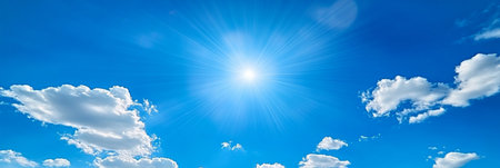 Vibrant Blue Sky with Fluffy White Clouds Under the Bright Sun, Capturing Summer s Natural Beautyの素材
