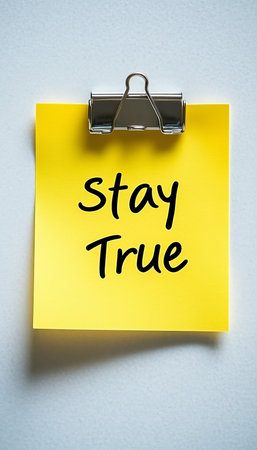 Inspirational Quote Stay True Written On A Yellow Sticky Note Attached To A White Backgroundの素材