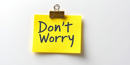 Cheerfully Encouraging Reminder Don t Worry Pinned on Adhesive Note Against Calm Gentle Background.の素材