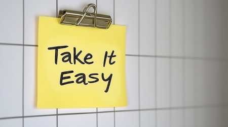 Inspirational Sticky Note on Office Desk, Bright Yellow with a Positive Message to Boost Your Dayの素材