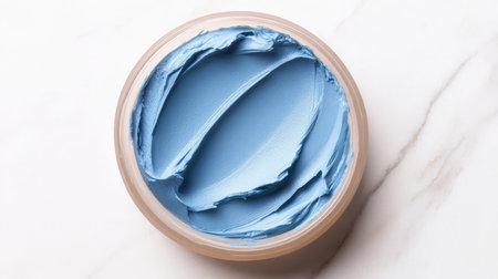 Luxurious Face Cosmetics Composition Featuring Light Blue Foundation Swirl and Creamy Beauty Circleの素材