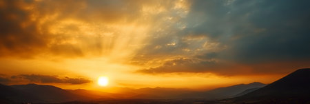 Breathtaking Golden Sunrise Over Majestic Mountain Range with Dramatic Sky and Beautiful Cloudsの素材