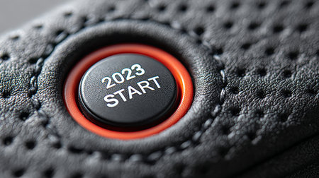Embark on New Ventures Button Displays 2023 Sign Against Luxurious Black Leather Vehicle Textureの素材
