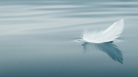 A Serene White Feather Floating Gently on a Calm Water Surface, Reflecting a Peaceful Sceneの素材