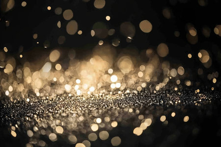 Subtle Luminescence and Ethereal Radiance Golden Ambiance with Bokeh Effect on Black Surfaceの素材