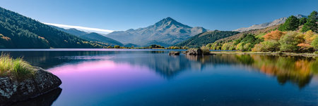 Stunning Majestic Mountain Landscape with Vibrant Autumn Colors Reflected in a Tranquil Lake Sceneの素材