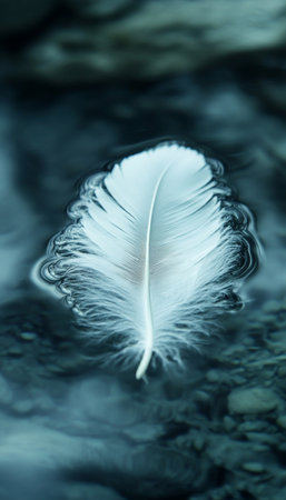 A Single White Feather Gracefully Drifting on Calm Water, Symbolizing Purity and Transformationの素材