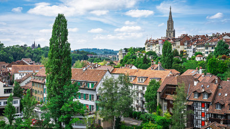 Bern, Switzerland A Picturesque View of the Old City with Towering Architecture and Trees
