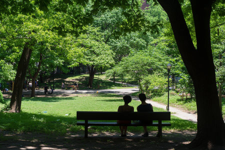 Tranquil Serenity Couple Embracing Nature s Calm on a Park Bench Surrounded by Lush Greeneryの素材