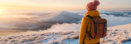 A Peaceful Explorer Taking a Break While Admiring the Vast Mountain Landscape Under a Sunny Skyの素材