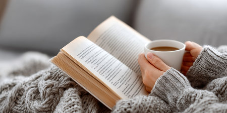 Cozy and Inviting Atmosphere with a Warm Cup of Coffee and an Open Book on a Chilly Dayの素材