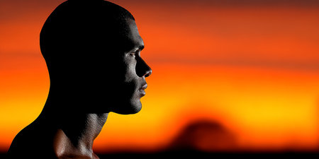 Silhouette of a Determined Individual Against a Vibrant Sunrise, Symbolizing Hope and Ambitionの素材