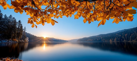 Tranquil Autumn Landscape Vibrant Golden Leaves Surround a Serene Lake at Sunset with Mountainsの素材