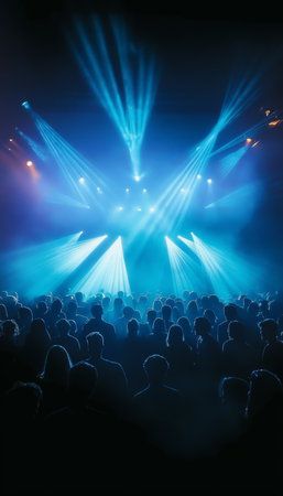 Energetic Nightclub Scene with Blue Stage Lights and Vibrant Crowd at an Indoor Concert Eventの素材