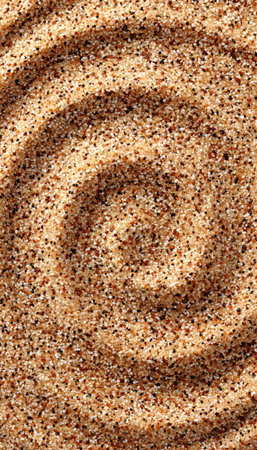 Swirling Layers of Earthy Fine Sand Create Intriguing Textural Patterns in a Circular Motif Designの素材