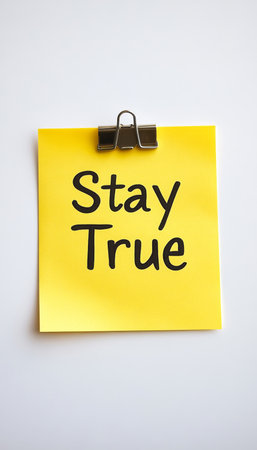 A Thoughtful Yellow Sticky Note on a Desk Emphasizing the Importance of Honesty and Commitmentの素材