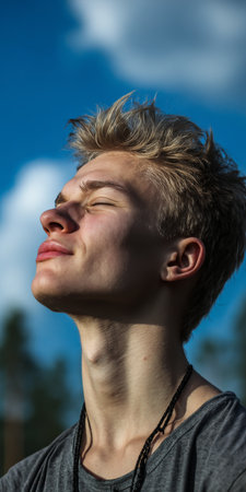 Carefree Young Man Enjoying Serenity and Relaxation in Natural Environment Beneath Azure Skyの素材