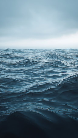 Endless Navy Ocean Waters with Gentle Waves under a Subtle Icy Blue Layer above the Cold Seaの素材
