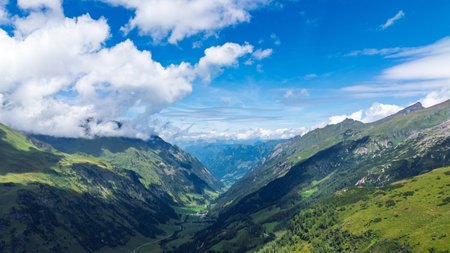 Majestic Alpine Valley Vista in Austria Alps A Breathtaking Summer Landscape Panoramaの写真素材