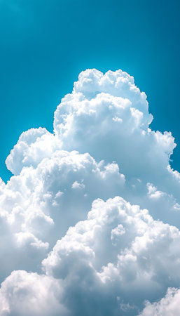 Billowy White Clouds Ascending Gracefully in Soft Blue Sky Against Bright Sunny Day, Nature s Beautyの素材
