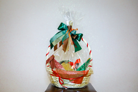 gift wrapping and packaging for a birthday, basket with gifts in celaphaneの写真素材