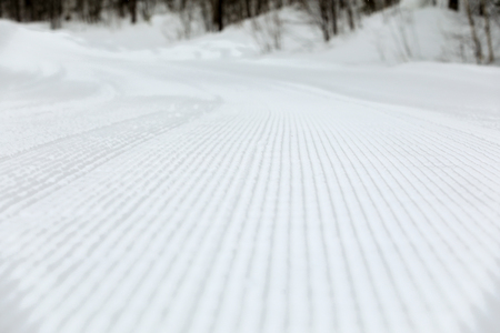 snow pattern on the ski slope after the work of a special machineの写真素材
