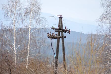 masts of old electricity transmission line to the cityの写真素材