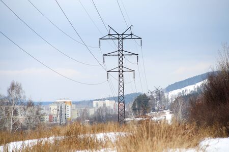 masts of old electricity transmission line to the cityの写真素材