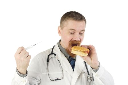 Bearded doctor isn't sure: eat the hamburger he is holding or make it an injection with a syringeの写真素材