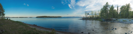 Coastal wooded islands and calm sea in the Kandalaksha Bay