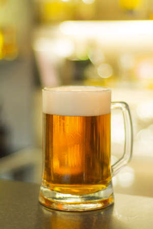 Light beer in a glass mugの写真素材