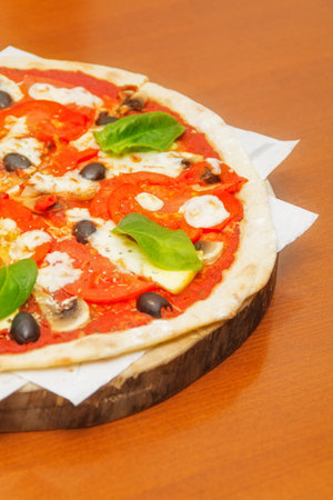 Pizza with olives, mushrooms and baconの写真素材