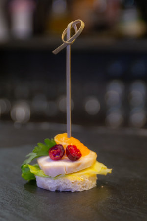 Canape with ham, cheese and mandarinの写真素材