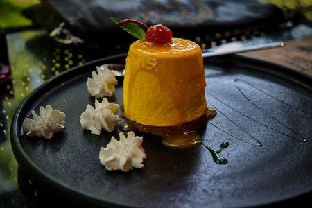 Dessert. Mango passion fruit with cherry and green mint.の写真素材
