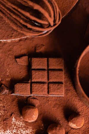 Delicious homemade chocolate preparation process. All kitchen tableware covered with cocoa powder. Intense brown color, aromatherapy. Dark and moody, macro, flat lay, top viewの写真素材