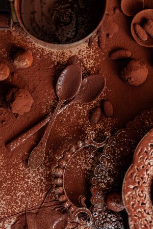 Delicious homemade chocolate preparation process. All kitchen tableware covered with cocoa powder. Intense brown color, aromatherapy. Dark and moody, macro, flat lay, top viewの写真素材