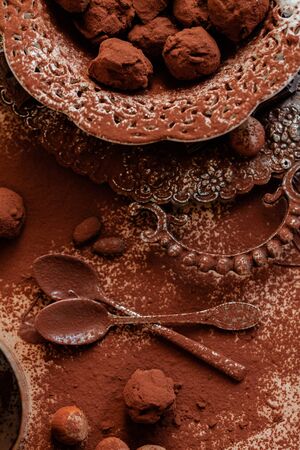 Delicious homemade chocolate preparation process. All kitchen tableware covered with cocoa powder. Intense brown color, aromatherapy. Dark and moody, macro, flat lay, top viewの写真素材
